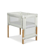 Born Light C03 bedside crib beside an adult bed with side rail lowered, bedside sleeper mode