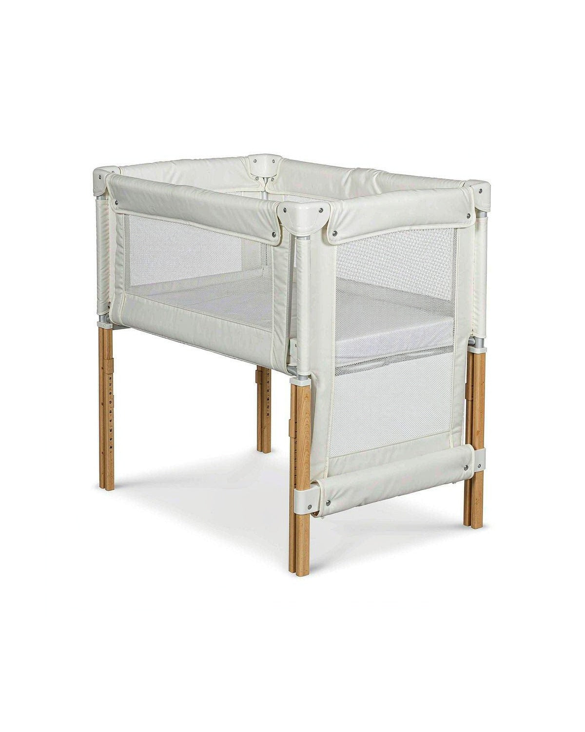 Born Light C03 bedside crib beside an adult bed with side rail lowered, bedside sleeper mode